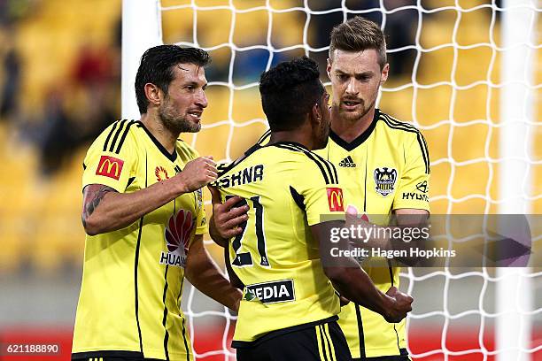Roy Krishna of the Phoenix is congratulated on his goal by teammates Vince Lia and Jacob Tratt during the round five A-League match between the...