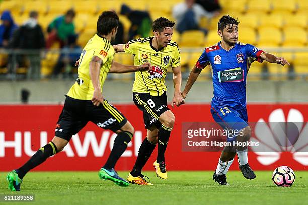 Ivan Vujica of the Jets is challenged by Gui Finkler and Alex Rodriguez of the Phoenix during the round five A-League match between the Wellington...