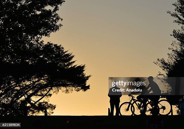 Silhouettes of supporters with bicycles are seen during a presidential election campaign rally, supporting Democrat Party's Presidential Candidate...