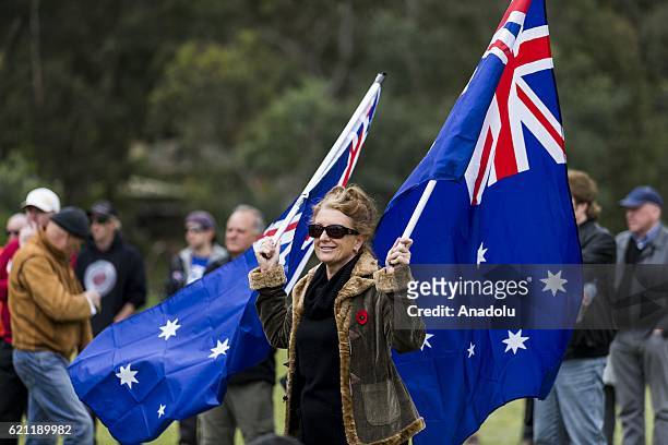 Anti-refugee protesters march with posters and Australian flags during pro and anti refugee rallies in Eltham, Melbourne, Australia on November 05,...