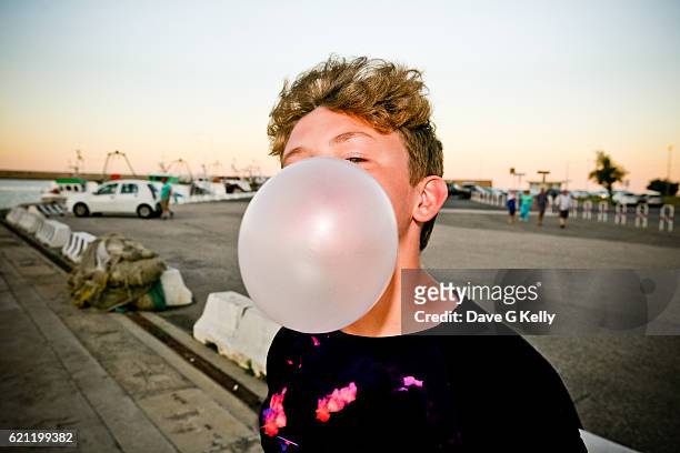boy blowing a bubble - bubble gum bubble stock pictures, royalty-free photos & images