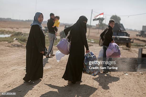 Civilians flee from the Zahara neighbourhood on the north eastern edge of Mosul the morning after it was taken back from ISIS by Iraqi Special...