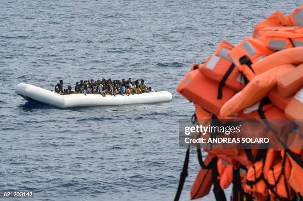 Migrants and refugees on a rubber boat wait to be evacuated during a rescue operation by the crew of the Topaz Responder, a rescue ship run by...