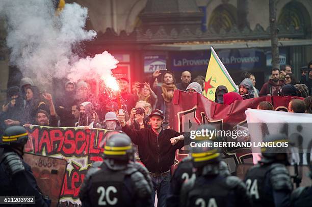 Pro-refugees demonstrators stand in front of riot police as they shout against French far-right Front National 's supporters in Marseille, southern...