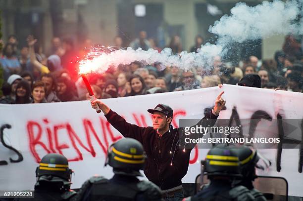 Pro-refugees demonstrators stand in front of riot police as they shout against French far-right Front National 's supporters in Marseille, southern...
