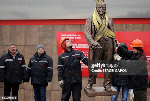 Workers install a statue of the first Soviet leader Vladimir Lenin near the Minsk Tractor Plant in Minsk on November 5 as a monument was carried...