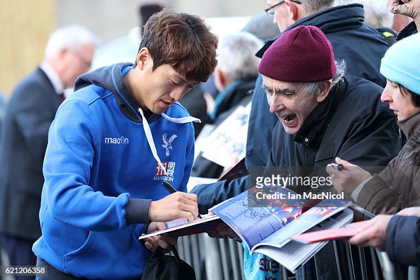 Chung-yong Lee of Crystal Palace arrives at the stadiium prior to kick off and signs fans autographs prior to kick off during the Premier League...