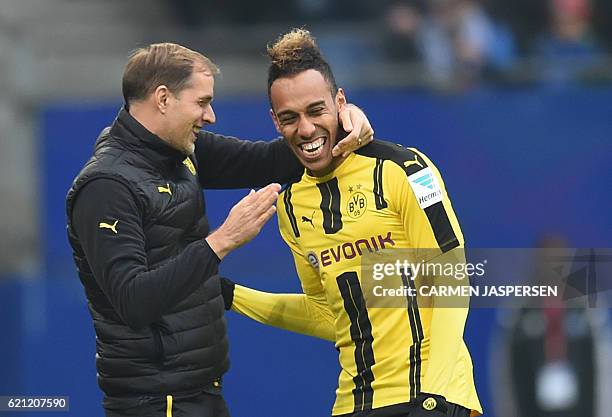 Pierre-Emerick Aubameyang from Dortmund celebrateS with coach Thomas Tuchel his goal during the German first division Bundesliga football match...