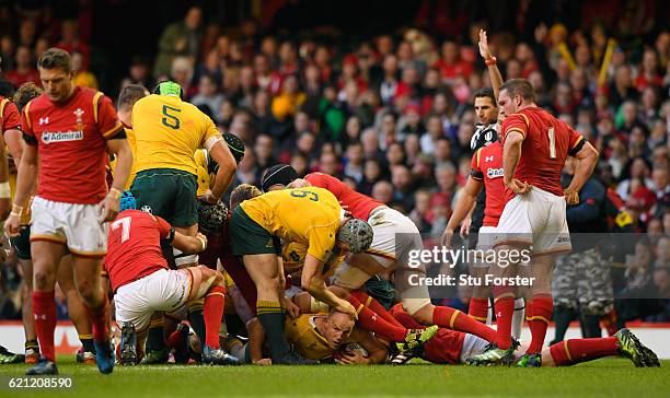 Stephen Moore of Australia is congratulated by teammates after scoring the opening try during the international match between Wales and Australia at...