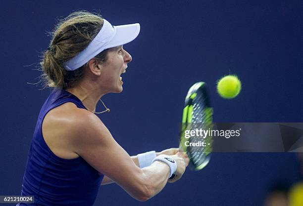 Johanna Konta of Britain hits a return against Elina Svitolina of Ukraine during their women's singles semi-final match at the WTA Elite Trophy...