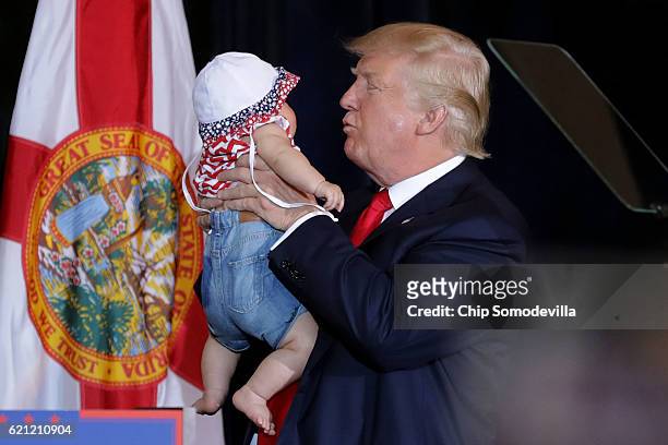 Republican presidential nominee Donald Trump kisses a baby during a campaign rally in the Special Events Center on the Florida State Fairgrounds...