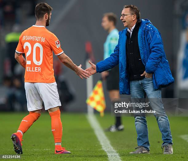 Marcel Heller of Darmstadt shake hands with Head Coach Norbert Meier of Darmstadt during the Bundesliga match between Bayer 04 Leverkusen and SV...