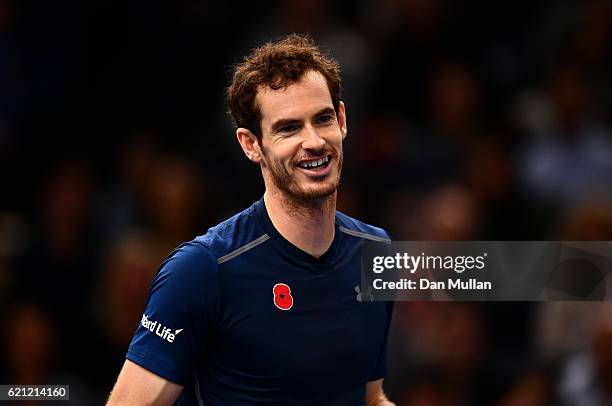 Andy Murray of Great Britain smiles on court following his walkover in the Mens Singles semi final match against Milos Raonic of Canada on day six of...