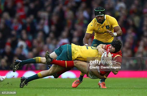 Leigh Halfpenny of Wales is tackled by Reece Hodge of Australia during the international match between Wales and Australia at the Principality...