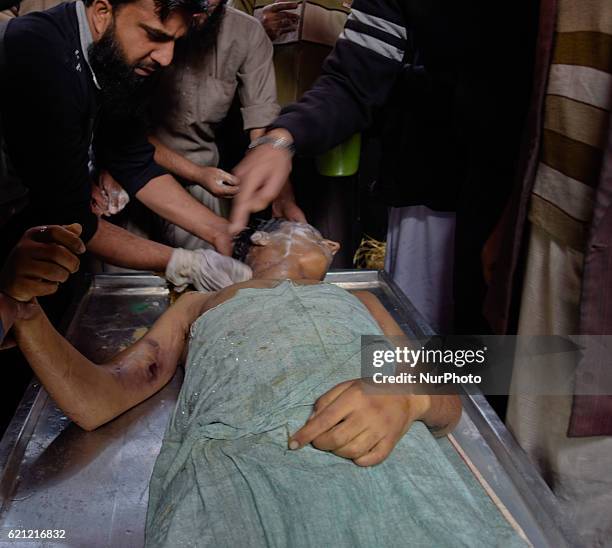 Kashmiri Muslims offer funeral prayers next to the body of Qaisar Sofi, a 16 year old boy who succumbed to his injuries, during his funeral on...