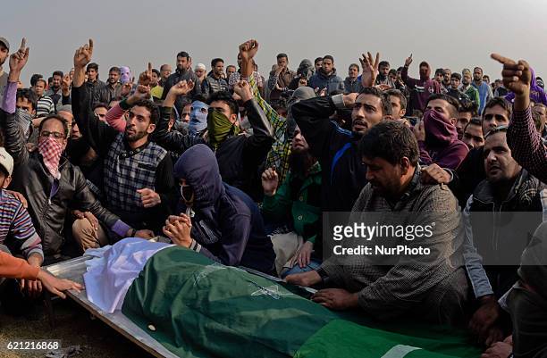 Kashmiri Muslims gather around the body of Qaisar Sofi, a 16 year old boy who succumbed to his injuries, during his funeral on November 05, 2016 in...
