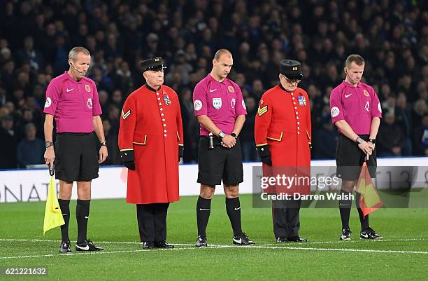 Referee Robert Madley and his two assisstants Mick McDonough , Marc Perry take part in a minute silence with two chelsea pensioners in honour of...