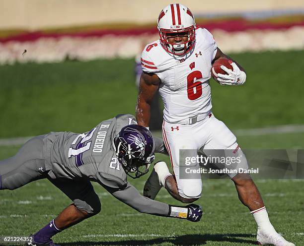 Corey Clement of the Wisconsin Badgers breaks a tackle attempt by Kyle Queiro of the Northwestern Wildcats at Ryan Field on November 5, 2016 in...