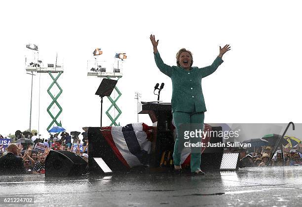 Democratic presidential nominee former Secretary of State Hillary Clinton greets suppoters in the rain during a campaign rally at C.B. Smith Park on...