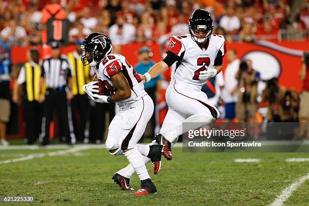 Atlanta Falcons running back Terron Ward takes a hand off from Atlanta Falcons quarterback Matt Ryan during the NFL game between the Atlanta Falcons...