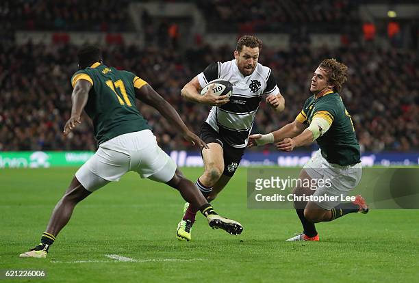 Luke Morahan of Barbarians runs between Jamba Ulengo and Rohan Janse Van Rensburg of South Africa to score their fifth try during the Killik Cup...