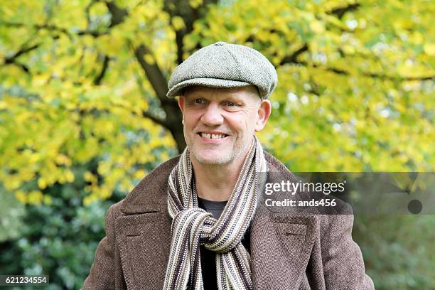 happy mature man outdoors - flat cap stock pictures, royalty-free photos & images