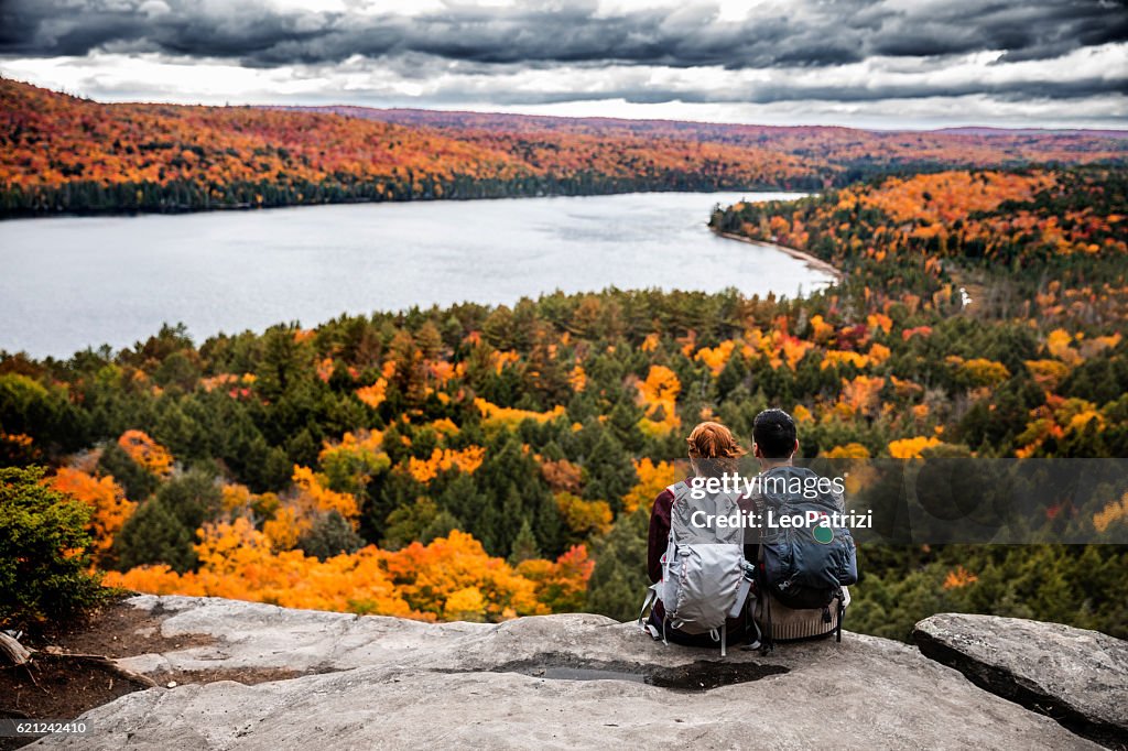 Young couple hiking in mountain and relaxing looking at view