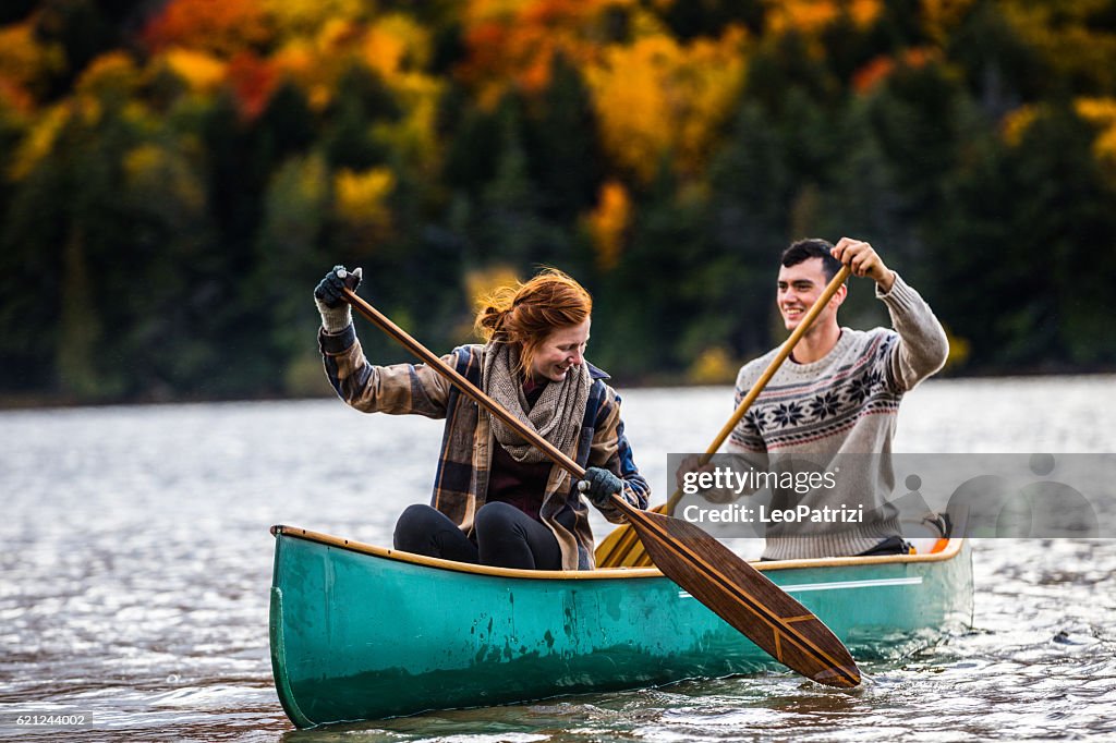 Couple enjoying a ride on a typical canoe in Canada
