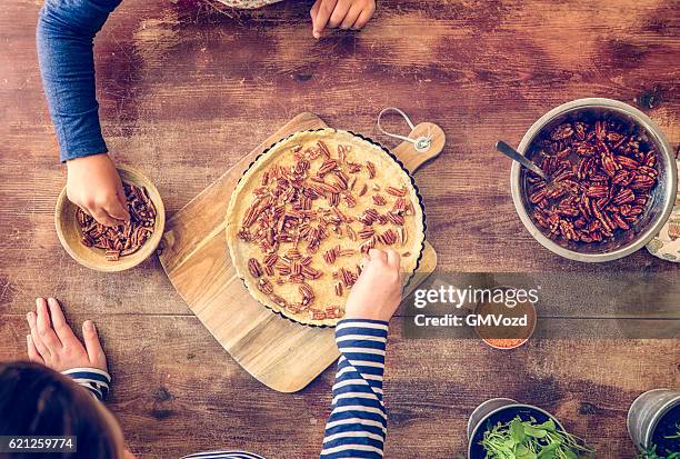 preparing homemade pecan pie for the holidays - pecan pie stock pictures, royalty-free photos & images