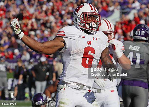 Corey Clement of the Wisconsin Badgers celebrates after socring a 4th quarter touchdown against the Northwestern Wildcats at Ryan Field on November...