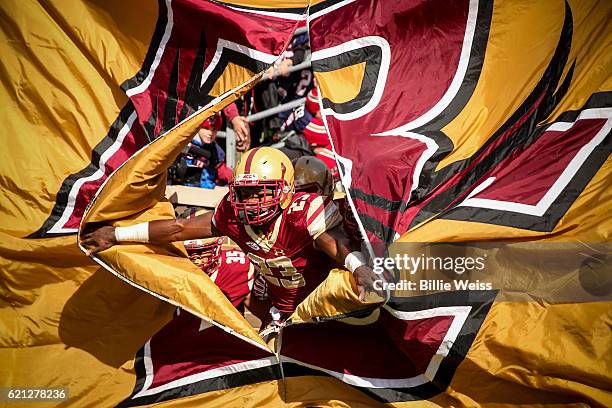 Myles Willis of Boston College breaks through a flag as the team is introduced before a game against Louisville at Alumni Stadium on November 5, 2016...