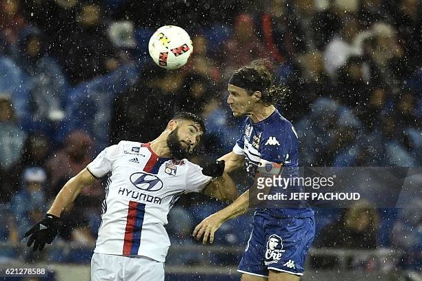 Lyon's French midfielder Nabil Fekir vies with Bastia's French midfielder Yannick Cahuzac during the French L1 football match Olympique Lyonnais vs...