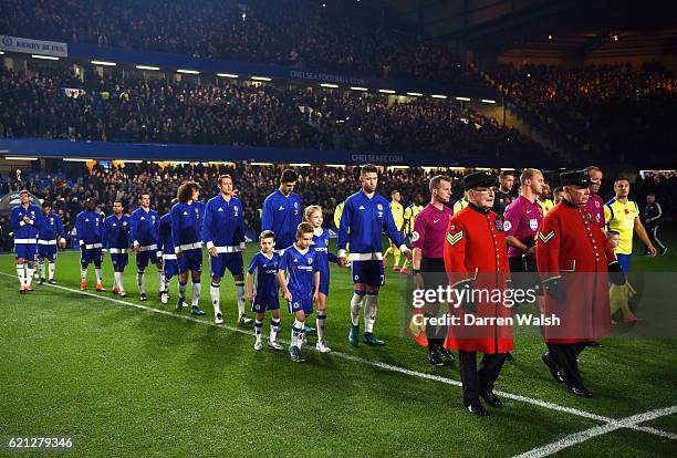 Two chelsea pensioners lead the two teams out during the Premier League match between Chelsea and Everton at Stamford Bridge on November 5, 2016 in...