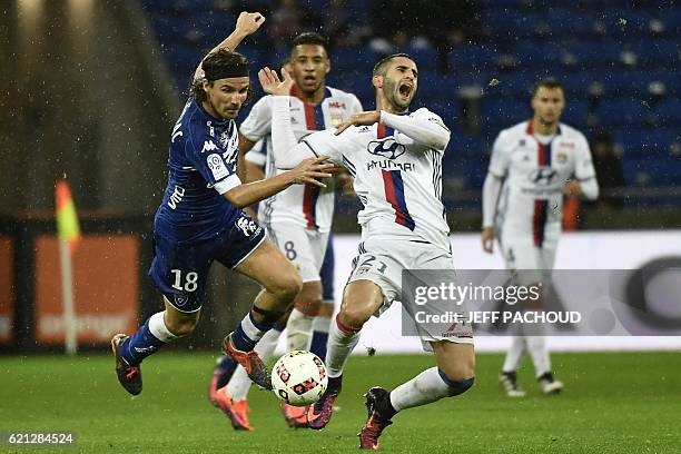 Bastia's French midfielder Yannick Cahuzac vies with Lyon's French midfielder Maxime Gonalons during the French L1 football match Olympique Lyonnais...