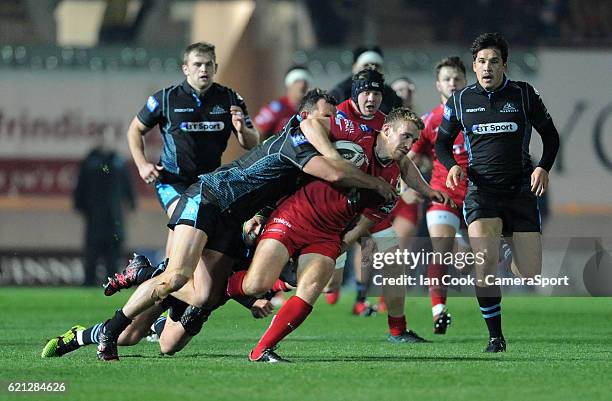 Scarlets' Jonathan Evans is tackled by Glasgow Warriors' Simone Favaro during the Guinness PRO12 Round 8 match between Scarlets and Glasgow Warriors...