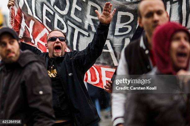 Right-wing activists shout slogans as they gather in front of Hauptbahnhof main railway station before marching through the city center on November...