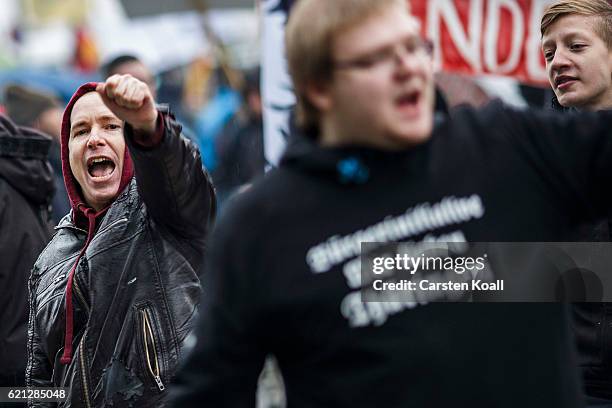 Right-wing activists shout slogans as they gather in front of Hauptbahnhof main railway station before marching through the city center on November...