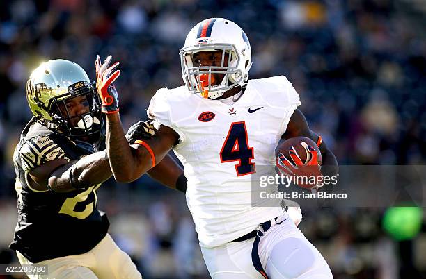 Running back Taquan Mizzell of the Virginia Cavaliers avoids linebacker Thomas Brown of the Wake Forest Demon Deacons during a carry in the first...