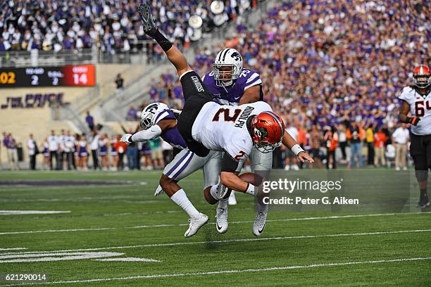 Quarterback Mason Rudolph of the Oklahoma State Cowboys leaps over defensive back Duke Shelley of the Kansas State Wildcats for a first down during...