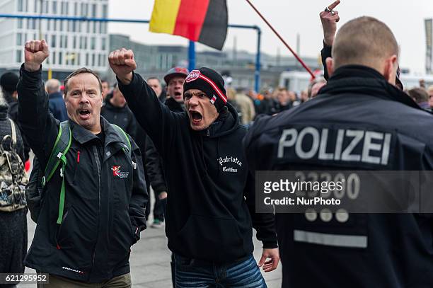 Right-wing activists shout slogans as they gather in front of Hauptbahnhof main railway station before marching through the city center on November...