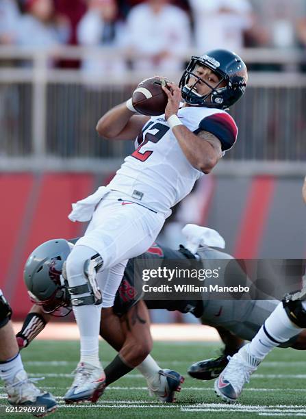 Quarterback Anu Solomon of the Arizona Wildcats is sacked by Shalom Luani of the Washington State Cougars in the first half at Martin Stadium on...