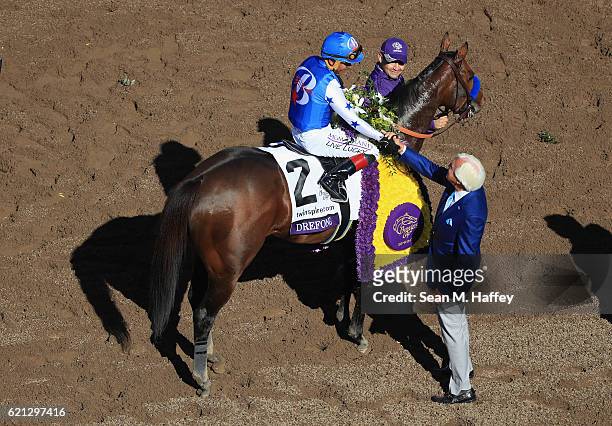Jockey Martin Garcia riding Drefong shakes owner Bob Baffert's hand after winning the TwinSpires Sprint race on day two of the 2016 Breeders' Cup...