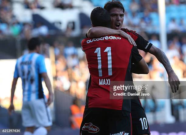 Mauro Formica, of Newell's Old Boys, celebrates with teammate Maximiliano Rodriguez, of Newell's Old Boys, after scoring during a match between...