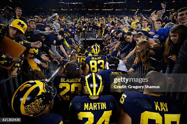 Fans cheer on the Michigan Wolverines as they leave the field after a 59-3 win over the Maryland Terrapins on November 5, 2016 at Michigan Stadium in...