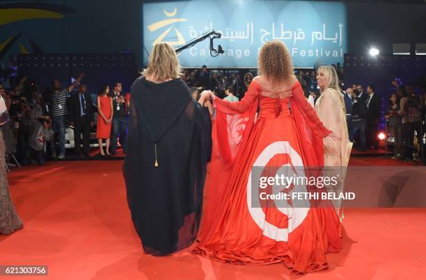 Cinephile women arrive at the closing ceremony of the 27th Carthage Film Festival on November 5, 2016 in the Tunisian capital Tunis. / AFP PHOTO /...