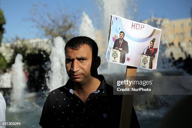 Kurd holds a photo of Selahattin Demirtas arrested leader of Peoples' Democratic Party taking part to a protest rally against the Turkish government,...