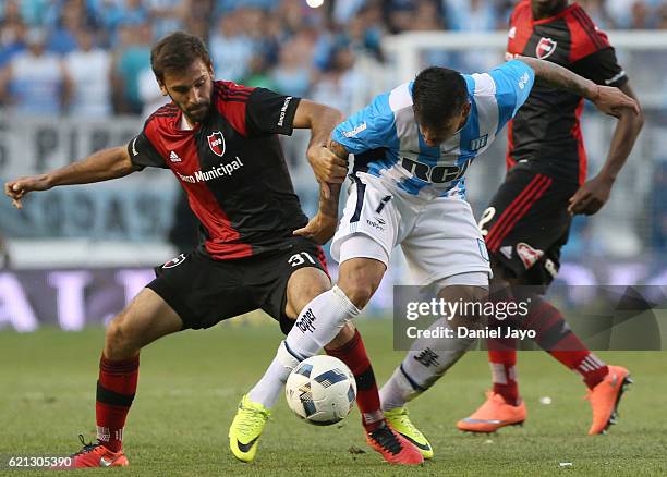 Facundo Quignon, of Newell's Old Boys, and Gustavo Bou, of Racing Club fight for the ball during a match between Racing Club and Newell's Old Boys as...