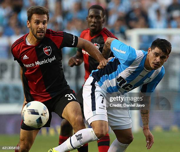 Facundo Quignon, of Newell's Old Boys, and Gustavo Bou, of Racing Club fight for the ball during a match between Racing Club and Newell's Old Boys as...