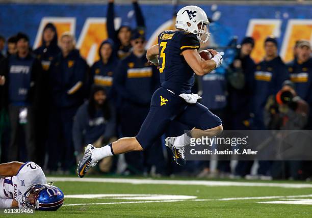Skyler Howard of the West Virginia Mountaineers rushes for a 33 yard touchdown in the first half against the Kansas Jayhawks during the game on...