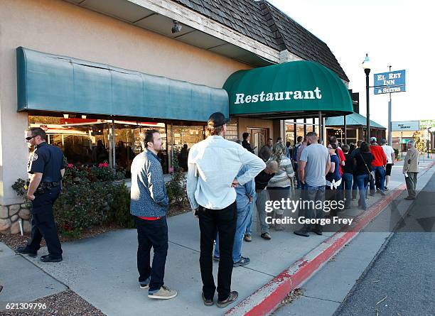 People line up in front of the Brick House Cafe for pictures with U.S. Independent presidential candidate Evan McMullin on November 5, 2016 in Cedar...